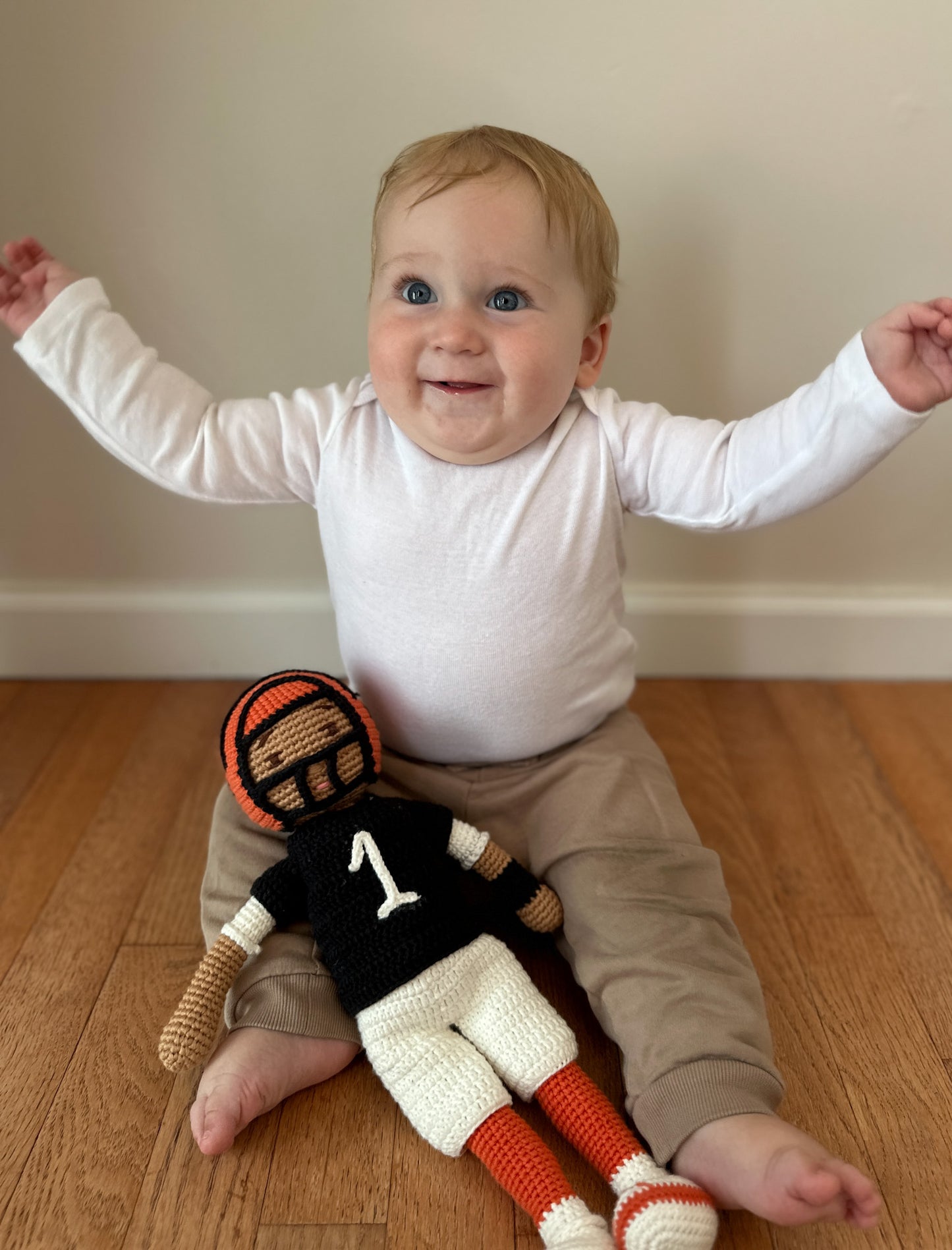 Rudy holding #1 doll sitting up